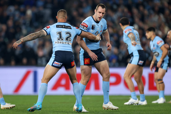 Isaah Yeo of the Blues stumbles after being hit while making the opening tackle.