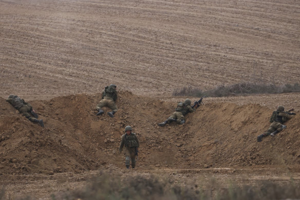 Israeli soldiers take position near the Israeli Gaza border, southern Israel.