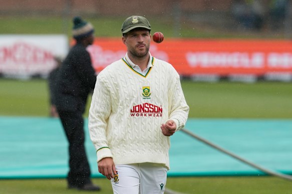 South Africa’s Wiaan Mulder tosses a ball as rain interrupts play on day five of the second cricket Test match between South Africa and Australia.