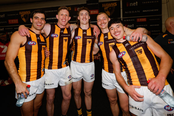 Sam Frost (second from left) after the Hawks defeated the Bulldogs on Friday night. 