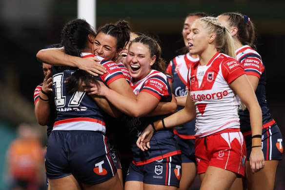 Otesa Pule celebrates her try with Roosters teammates.