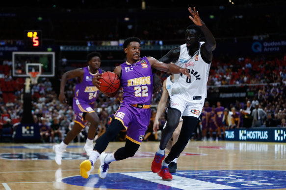 Casper Ware battles with Jo Lual Acuil during the third NBL semi-final match between the Sydney Kings and Melbourne United in March.