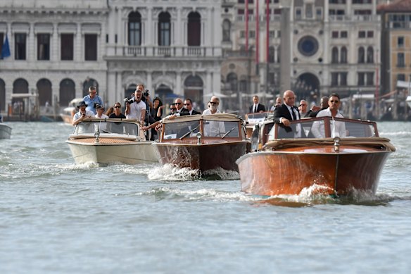 The boat carrying Jeff Bezos (center) passes in front of the expected wedding in the square of St Mark.