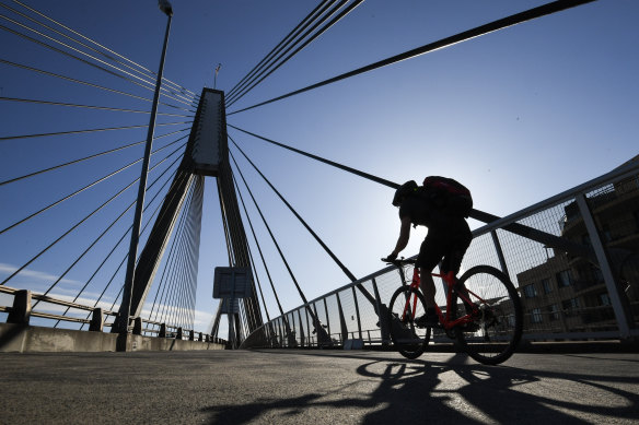 A cyclist on Sydney's Anzac bridge. Fears about using public transport have fuelled a spike in cycling's popularity.