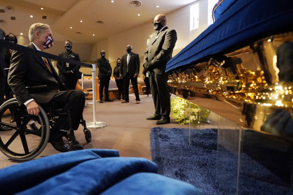Texas Governor Greg Abbott, left, stops to pray by the casket of George Floyd in Houston, Texas, on Monday.