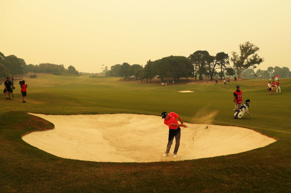 Sergio Garcia plays out of a bunker under a thick layer of haze over the Australian Golf Club in Sydney on Thursday.