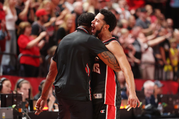 Tyler Harvey celebrates with coach Justin Tatum.