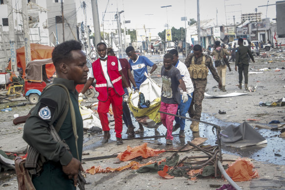 Rescuers remove a body from the scene of the bomb attack in Mogadishu.