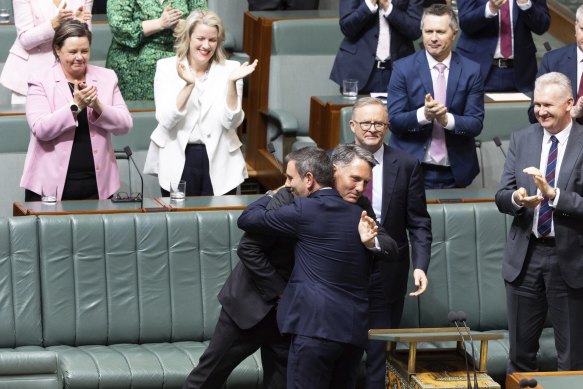 Deputy Prime Minister and Minister for Defence Richard Marles embraces Treasurer Jim Chalmers after the budget speech on Tuesday evening. 