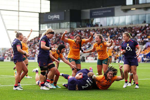 Faliki Pohiva of Australia celebrates as she goes over to score.