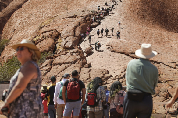 Visitors climbing up Uluru on Friday.