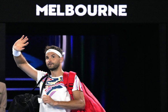 Grigor Dimitrov waves as he leaves Rod Laver Arena.