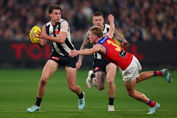 Jaspa Fletcher of the Lions tackles Patrick Lipinski of the Magpies.