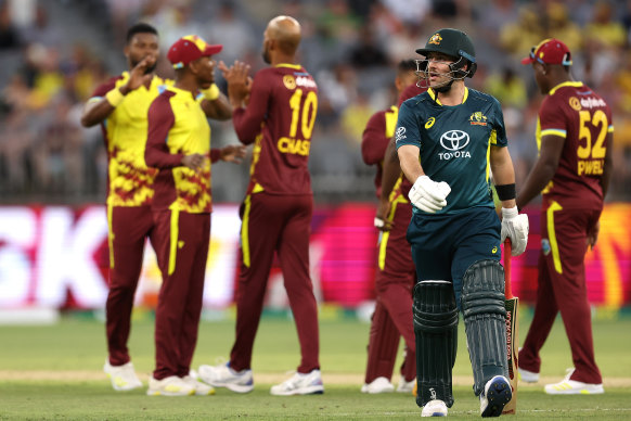 Josh Inglis walks from the field after being dismissed by Roston Chase of the West Indies.