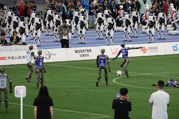 Robot teams face off in a soccer match.