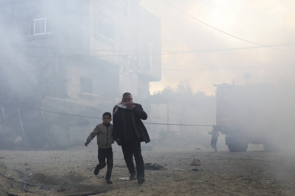 Palestinians flee after an Israeli strike on a residential building in Rafah on Monday. 