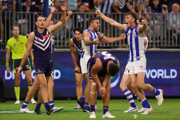 Kangaroos Griffin Logue and Nick Larkey celebrate as Fremantle players appeal for a free kick.
