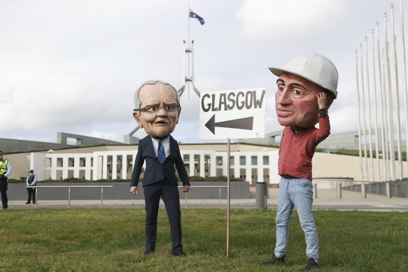 Protesters dressed as Prime Minister Scott Morrison and Deputy Prime Minister Barnaby Joyce on the lawns of Parliament House on Thursday.