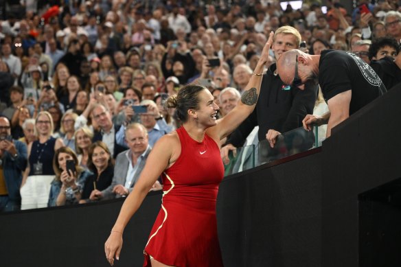 Sabalenka patting her fitness coach Jason Stacy’s lucky bald head.