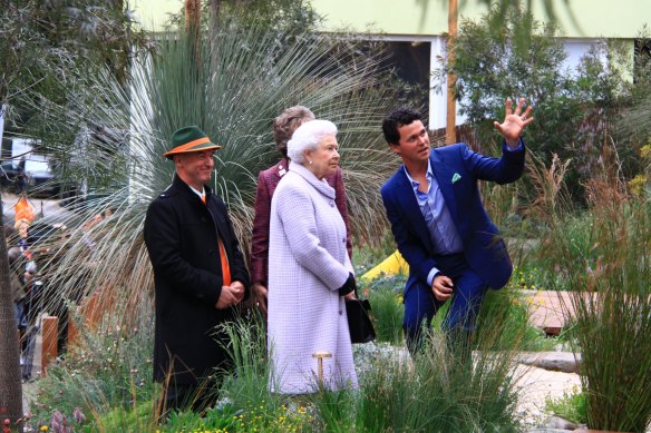 Phillip Johnson (right) and Wes Fleming take the Queen through their Chelsea Flower Show garden in 2013.
