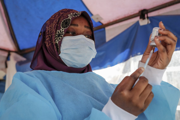 A nurse prepares to administer an AstraZeneca vaccination against COVID-19 at a district health centre in Nairobi, Kenya.
