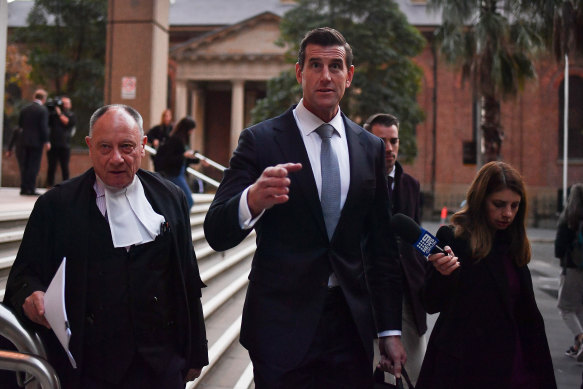 Bruce McClintock, SC, left, with Ben Roberts-Smith outside court on the first day.