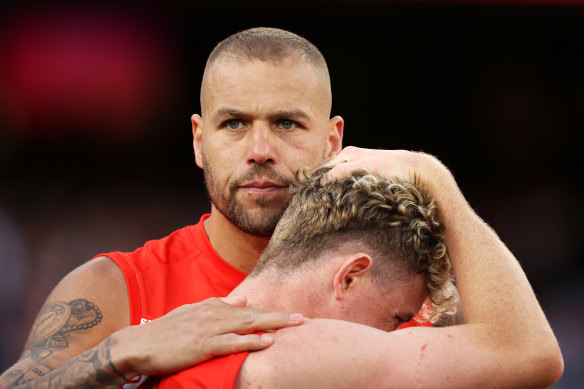 Lance Franklin consoles Chad Warner, the man who set up his famous 1000th goal, after Sydney’s grand final debacle.