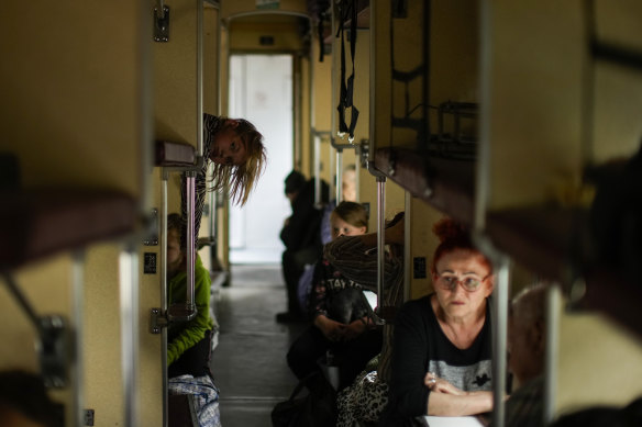 People fleeing from Lysychansk and other areas sit in an evacuation train at the train station in Pokrovsk, eastern Ukraine.