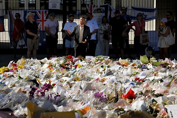 Rabbi Yossi Friedman leads people in prayers at the Bondi Pavilion at Bondi Beach on December 19.