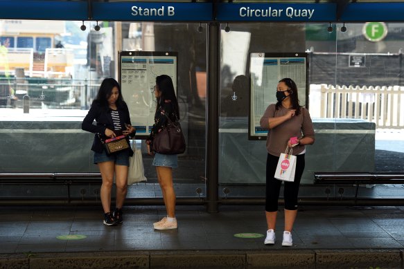 Passengers wait for a bus at Circular Quay on Monday.