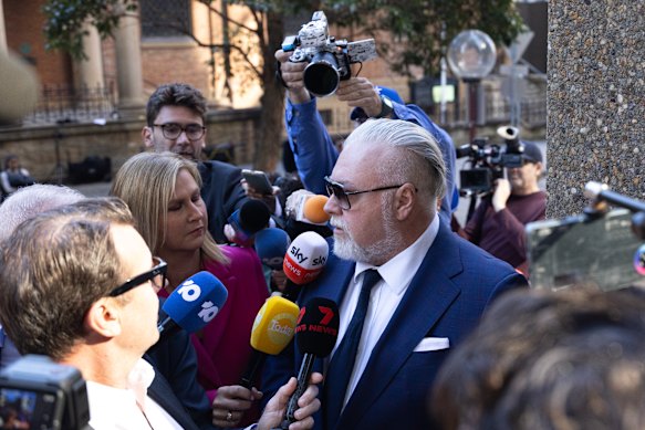 Kyle Sandilands was thronged by the media on his arrival at the Federal Court on Friday.