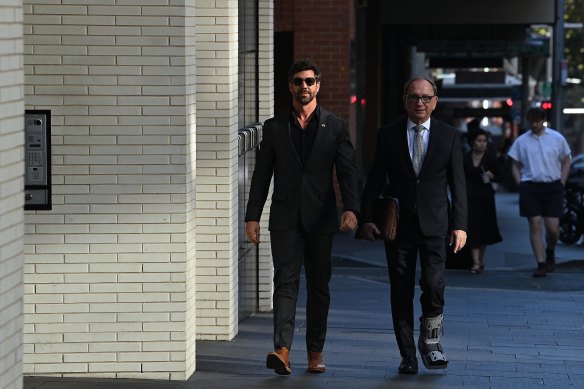 Heston Russell (left) arrives at Downing Centre Local Court on Monday with his lawyer Michael Bowe.