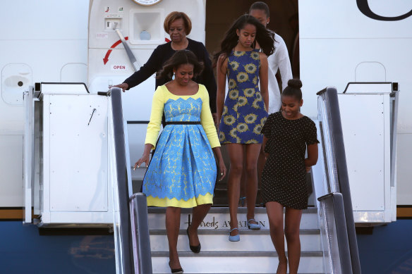 Then US first Lady Michelle Obama arrives with daughters Malia, centre, and Sasha Obama, right, and her mother Marian Robinson in London in 2015.