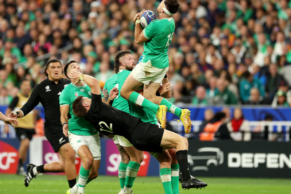 PARIS, FRANCE - OCTOBER 14: Hugo Keenan of Ireland wins the ball as Jordie Barrett of New Zealand falls to the ground during the Rugby World Cup France 2023 Quarter Final match between Ireland and New Zealand at Stade de France on October 14, 2023 in Paris, France. (Photo by Warren Little/Getty Images)