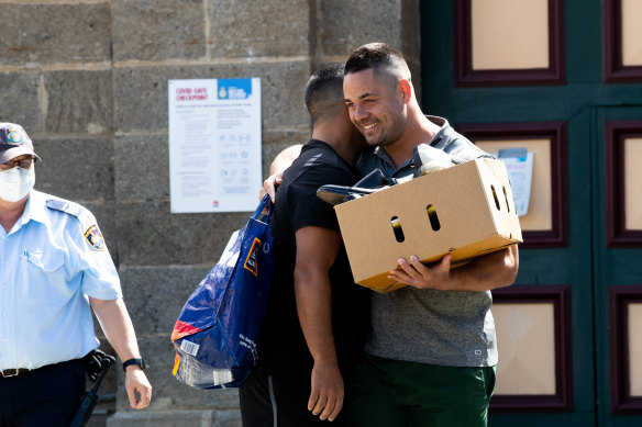 Jarryd Hayne hugs a friend after being released from custody.