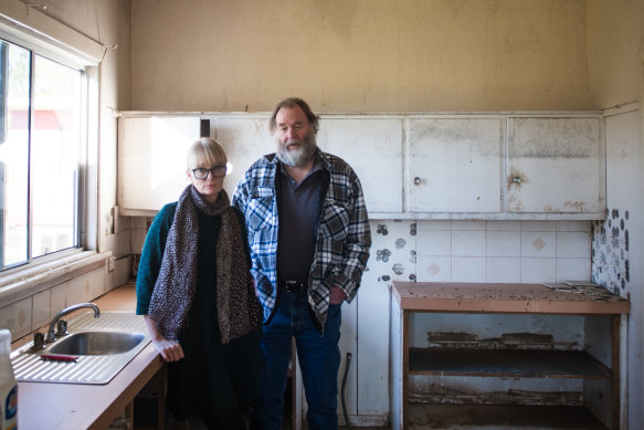 “She wouldn’t have been able to withstand the strength of that water,” says Susan Mills of her friend. The floodwater peak left a line on the kitchen cabinets.