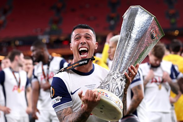 Pedro Porro of Tottenham Hotspur poses for a photograph with the UEFA Europa League trophy.