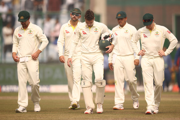 The Australians leave the field after defeat in Delhi.