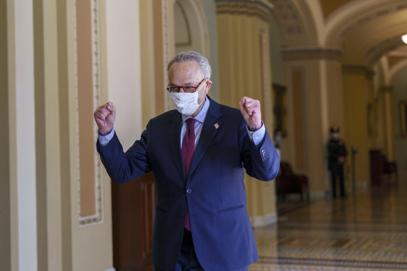 Senate Majority Leader Chuck Schumer pumps his fists in celebration after President Joe Biden’s $US1.9 trillion stimulus package passed the chamber. 