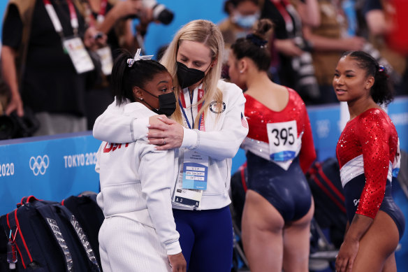 Simone Biles is comforted by coach Cecile Landi.