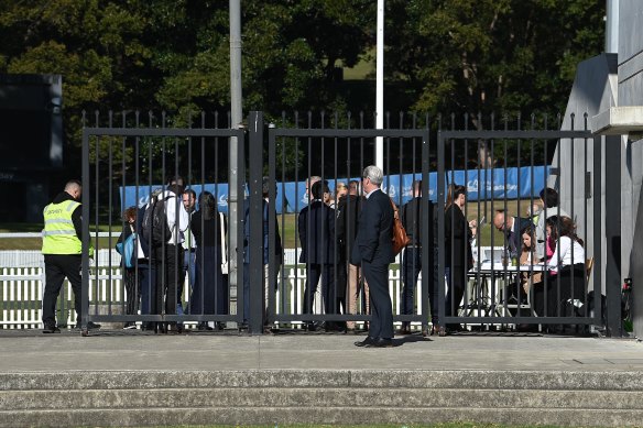 People arrive for the Toplace creditors’ meeting at Drummoyne Oval on Wednesday, after the company went into administration.