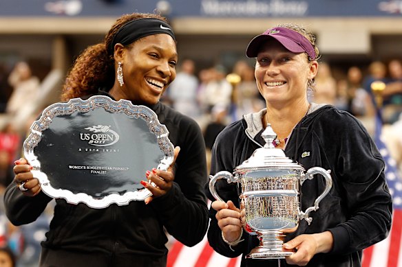 Sam Stosur celebrates with the championship trophy alongside Serena Williams after their Women’s Singles Final match at the US Open in 2011.