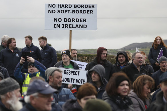 Demonstrators hold banners on the Northern Ireland/Republic of Ireland border, near Newry in Northern Ireland, in 2019. An open border between the two countries is central to the Good Friday Agreement.
