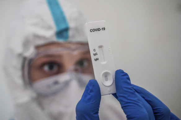 A health worker performs a rapid IgG/IgM test for COVID-19 antibody detection at a corona test centre in Berlin, Germany.