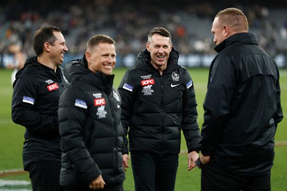 Collingwood man-manager Craig McRae with his coaching group. Or, the Pies coach with his assistants.