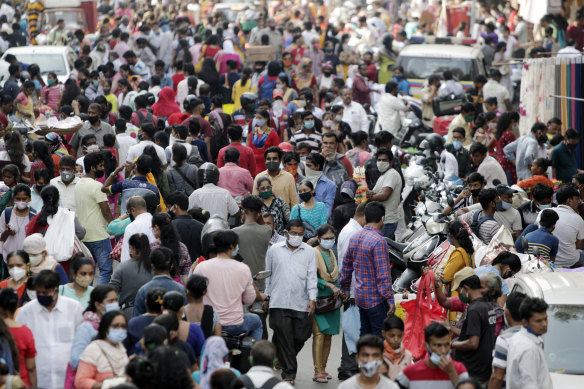 People wearing masks as a precaution against the coronavirus crowd a market place as they shop ahead of Diwali festival in Mumbai, India. India’s tally of coronavirus cases is currently the second largest in the world behind the United States.