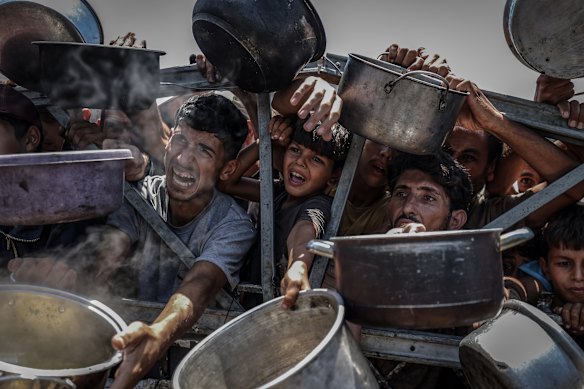 Palestinians, including children, line up this week in Gaza City to receive food.