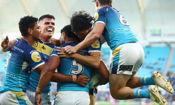 The Titans celebrate a try by winger Greg Marzhew.