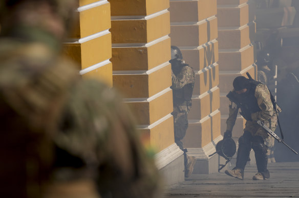 Soldiers walk amid tear gas they fired outside the Legislative Assembly in Plaza Murillo in La Paz, Bolivia.