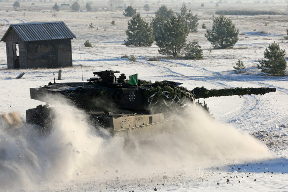A German Bundeswehr Leopard tank drives through the snow in preparation for a Dutch-German military exercise.